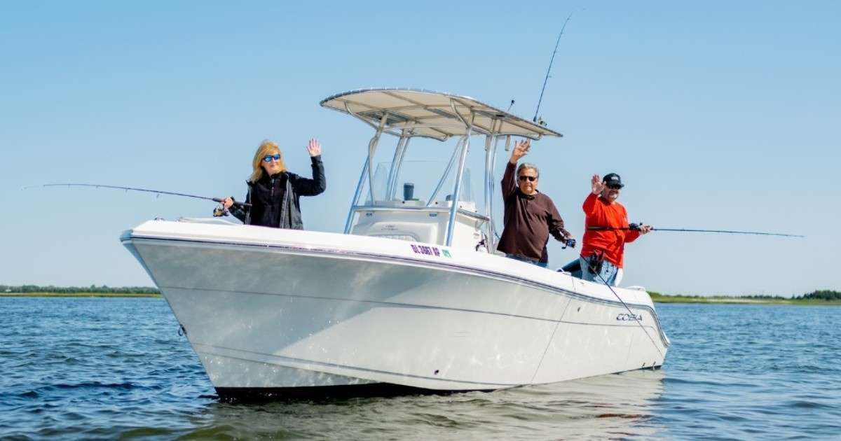 Three people fishing in a boat from Freedom Boat Club