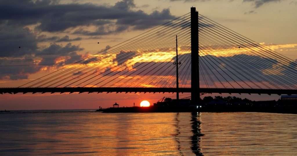 Silhouette of the Indian River Bridge in Delaware during sunrise near Indian River Inlet.
